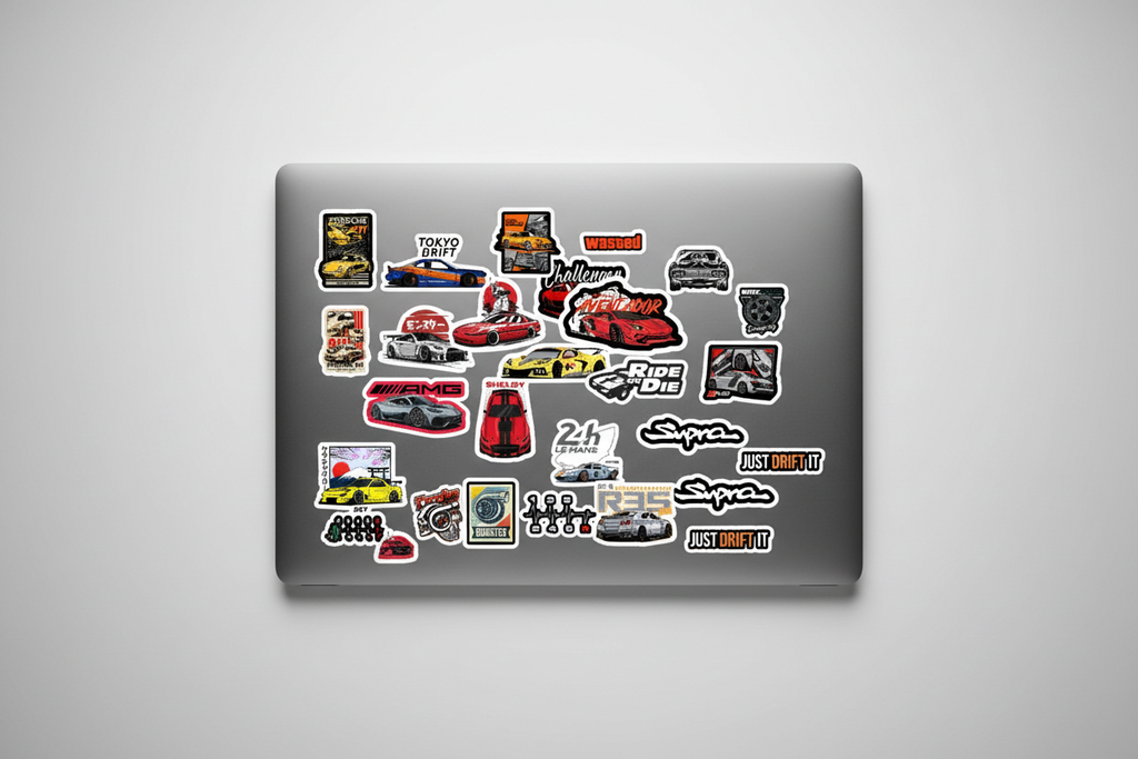 Laptop with various stickers on a gray background